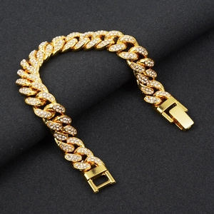 Close-up of hip-hop gold plated flat Cuban link bracelet with sparkling white zircons