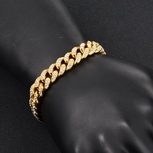 Detailed close-up of hip-hop iced out golden cuban link chain with sparkling rhinestones
