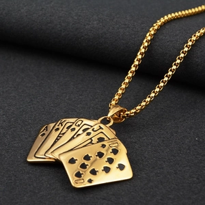 Macro detail of royal flush poker pendant on a golden box chain over grey texture