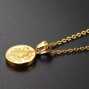 Macro shot of gold St. George slaying the dragon coin pendant with an O-chain link