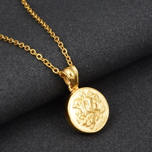 Close-up of golden Saint George and the Dragon relief pendant with fine chain link