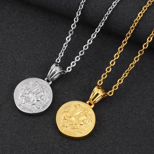 Macro view of gold and silver St George coin pendants with detailed relief engraving