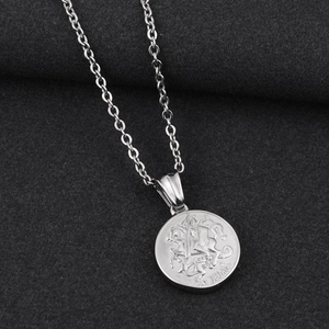 Detailed macro view of St. George pendant with circular coin relief on silver O-chain