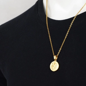 Polished gold Saint George coin pendant necklace on black shirt for a hip hop streetwear look