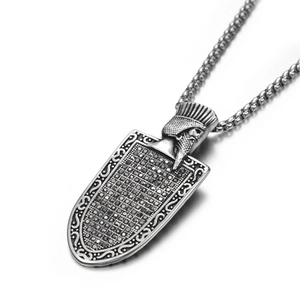 Detail of vintage shield pendant with black zircons and Persian figure on steel chain
