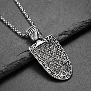 Macro detail of vintage shield pendant with pharaoh motif and black rhinestones