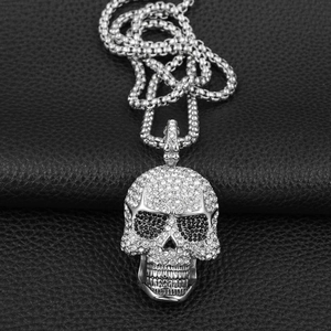 Makroaufnahme des glitzernden Totenkopf-Anhängers mit weißen und schwarzen Kristallen