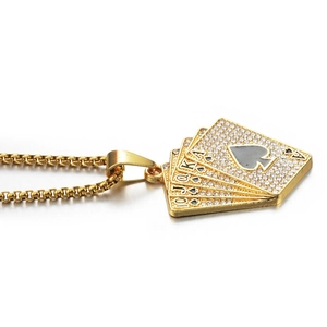 Macro shot of gold-plated poker cards pendant with sparkling crystals on box chain