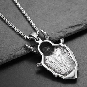 Macro shot of Viking ram horn mask pendant in aged titanium steel with box chain
