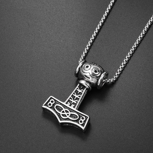Macro shot of Viking Mjölnir pendant in antique silver finish with Nordic runes