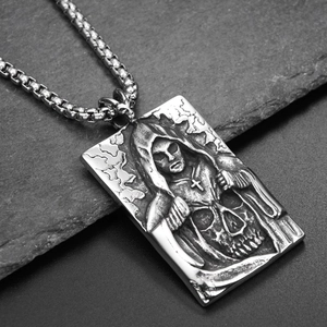 Macro view of gothic grim reaper relief on vintage square steel pendant necklace