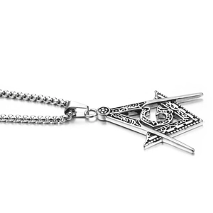 Vintage silver stainless steel Freemasonry G pendant with box chain on a white background