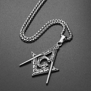 Detailed macro view of Masonic pendant with G symbol and intricate vine engravings