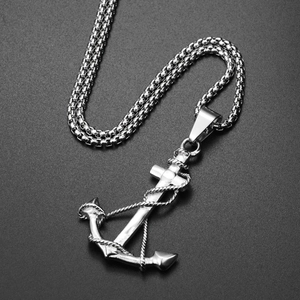 Macro shot of polished silver stainless steel anchor pendant with rope detail on box chain