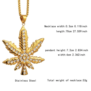 Detailed macro view of gold-plated stainless steel maple leaf pendant with iced out stones