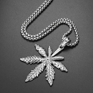 Detail of vintage silver maple leaf pendant with textured veins on box chain necklace
