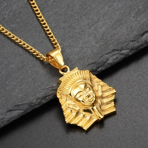 Macro detail of golden Pharaoh Tutankhamun pendant with hip-hop style Cuban chain