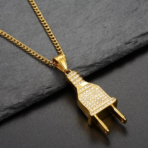 Macro shot of gold hip hop plug pendant with shimmering zircons on dark stone background
