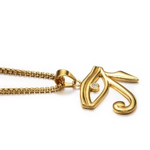 Golden Horus eye pendant necklace with central crystal on a sleek pearl chain