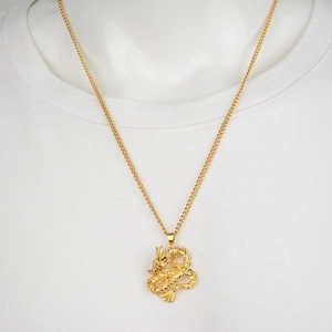 Classic golden Chinese dragon pendant necklace featuring intricate embossed scale details