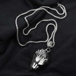 Detailed view of punk style silver wolf head pendant with textured fur and metal chain