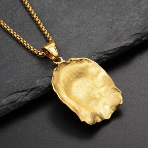 Detail of a gold-plated stainless steel box chain necklace with a brushed pendant back