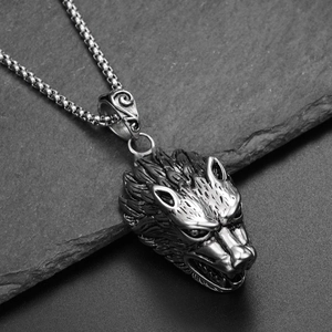Close-up of a wolf head pendant in vintage steel texture with detailed fur engravings