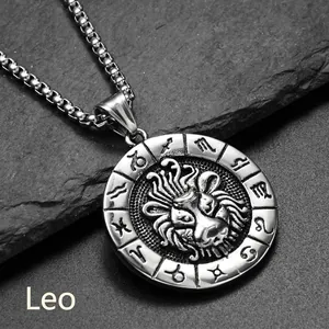 Gros plan détaillé du pendentif Lion en acier titane sur une surface de roche sombre