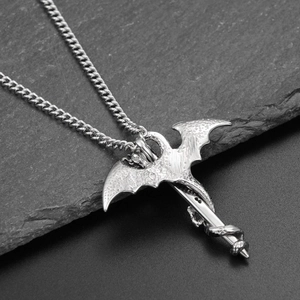 Detailed view of a silver dragon wrapped around a sword pendant on a steel chain