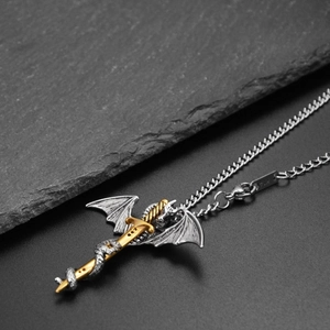 Macro shot of silver dragon wrapping around a golden sword pendant on a steel chain