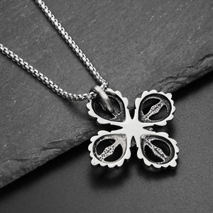 Macro shot of vintage titanium steel cross pendant on dark natural stone background