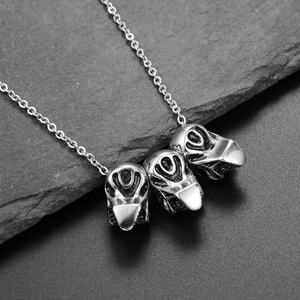 Detailed close-up of retro silver skull pendant with vintage industrial texture