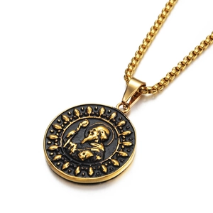 Detail of vintage religious gold saint pendant with embossed figure and box chain