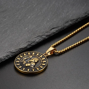 Macro shot of hip hop style gold coin pendant with religious relief on stone surface