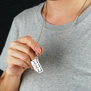 Detailed close-up of a minimalist hollow geometric rectangle pendant on a silver chain