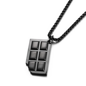 Detail of black bitten chocolate bar pendant necklace with sleek box chain