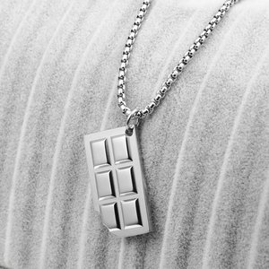 Macro shot of silver chocolate bar pendant with bitten corner detail on steel chain