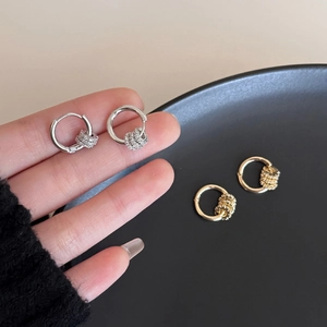 Elegant gold and silver hoop earrings featuring textured bead charms for a stylish look