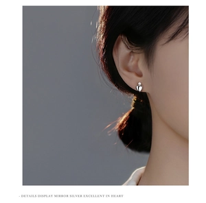 Close-up of S925 sterling silver heart pearl earrings on model showing mirror finish