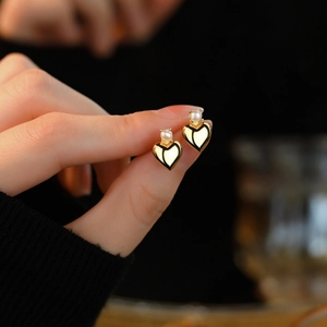 Elegant S925 sterling silver heart-shaped pearl stud earrings with a gold-plated finish