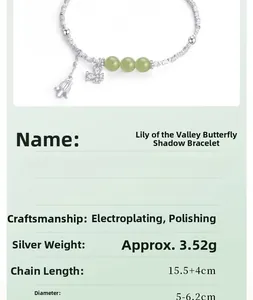 Detailed view of silver Lily of the Valley bracelet with jade beads and butterfly charm