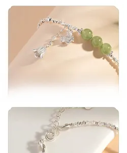 Detail of silver lily of the valley bracelet with green jade beads and diamond butterfly
