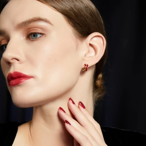 French vintage red enamel hoop earrings with gold trim on a high-end fashion model