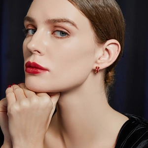 French vintage red enamel ribbon earrings with gold plating on a velvet background