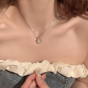 Moonstone pendant necklace for women with a minimalist silver chain shown on neck