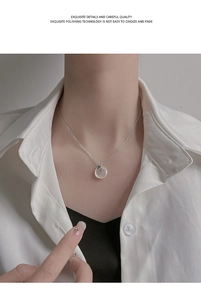 Close-up of a silver Ping'an Kou necklace with translucent jade and green leaf detail