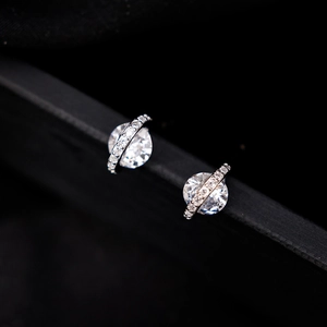 Close-up of saturn shaped spherical zircon stud earrings with crystal halo detail