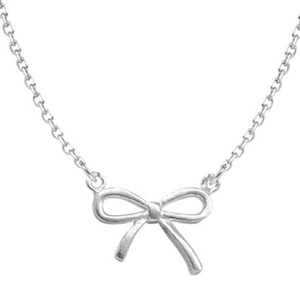 Minimalist silver ribbon bow pendant necklace with cross chain design on white background