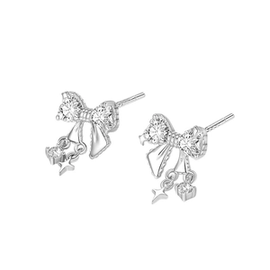 Silver bow stud earrings with heart cubic zirconia and star charms on white background