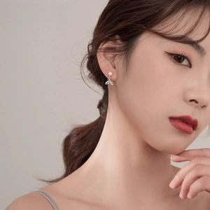 Elegant zircon fishtail pearl earrings for women shown on a model's side profile